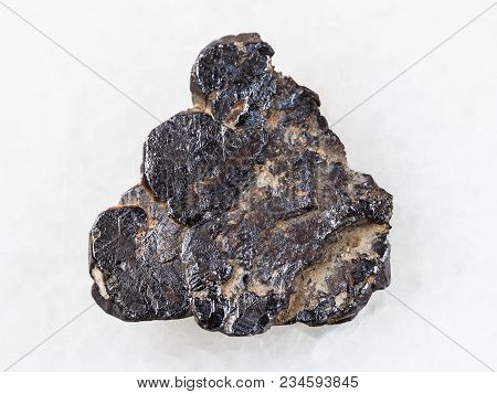 Macro Shooting Of Natural Mineral Rock Specimen - Ilmenite Stone On White Marble Background From Lov