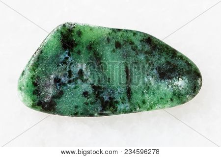 Macro Shooting Of Natural Mineral Rock Specimen - Tumbled Zoisite Gemstone On White Marble Backgroun