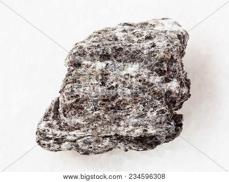 Macro Shooting Of Natural Mineral Rock Specimen - Piece Of Quartz-biotite Schist Stone On White Marb