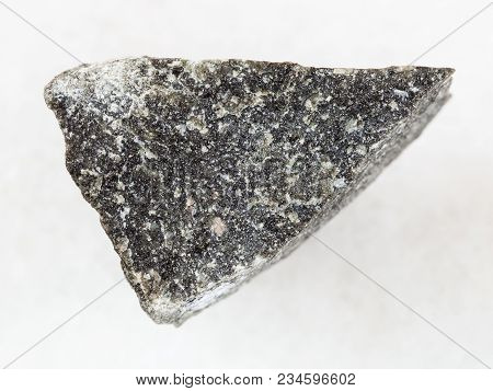Macro Shooting Of Natural Mineral Rock Specimen - Rough Andesite Stone On White Marble Background