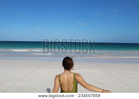 Girl Running Towards The Ocean In The Bahamas