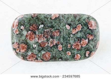Macro Shooting Of Natural Mineral Rock Specimen - Polished Eclogite Gemstone On White Marble Backgro