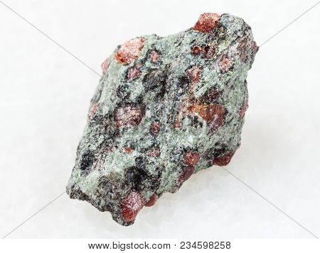 Macro Shooting Of Natural Mineral Rock Specimen - Raw Eclogite Stone On White Marble Background From