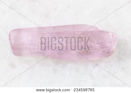 Macro Shooting Of Natural Mineral Rock Specimen - Tumbled Kunzite Gemstone On White Marble Backgroun