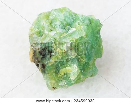 Macro Shooting Of Natural Mineral Rock Specimen - Raw Crystal Of Chrysopal Gemstone On White Marble 
