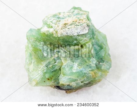 Macro Shooting Of Natural Mineral Rock Specimen - Crystal Of Chrysopal Gemstone On White Marble Back