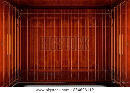 A Cross Section Birds-eye View Of The Inside Of An Empty Hot Operational Household Oven With A Glowi