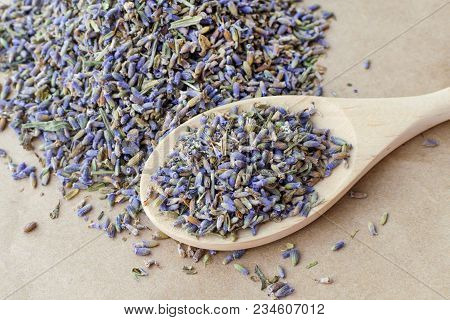 Wooden Spoon Full Of Dry Lavender Flowers Seeds Over Paper Background, Relaxation And Deep Sleep, Me