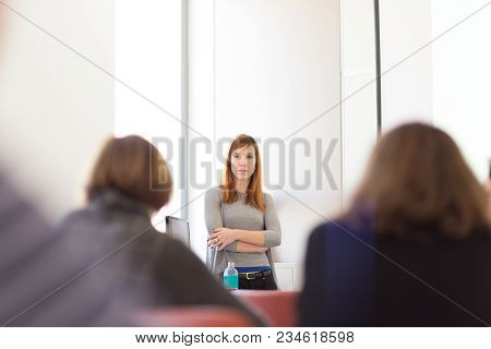 Woman Giving Presentation In Lecture Hall At University.