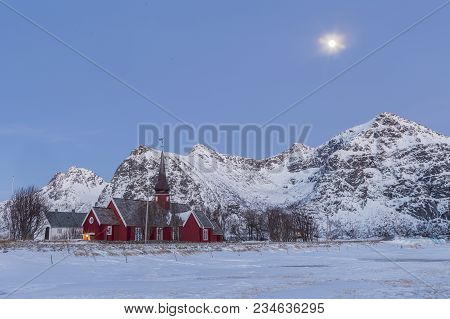 The Parish Church In Flakstad, A Red Wooden Chapel From 1870  Between Snowy Mountains Of Lofoten, No