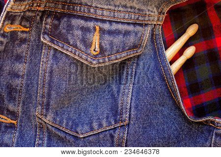 Drum Sticks Lie On A Scottish Cage And Jeans