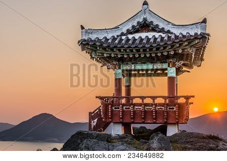 The Ancient Praying House On The Top Of Mountain With View On The Harbor And Sunset
