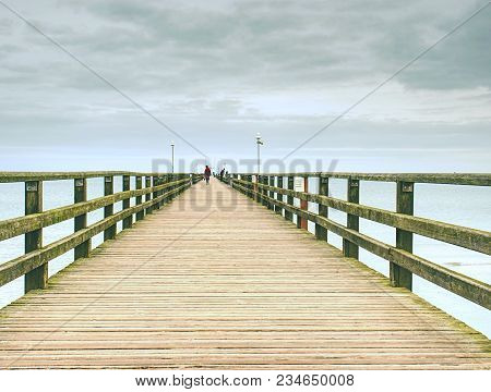 Wooden Pier In Summer Holiday Destination. Late Summer Landscape With Cloudy Sky.  Baltic Sea Coast 