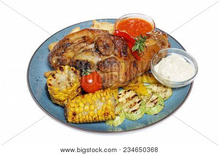 Fried Meat With Garnish Of Pepper, Zucchini, Tomato And Corn With Ajika Sauce Served On A Gray Plate