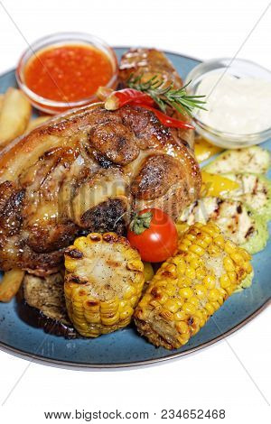 A Large Piece Of Meat With Corn And Potatoes