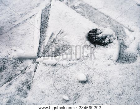 Top Down View Of Hockey Puck And Skates On Ice