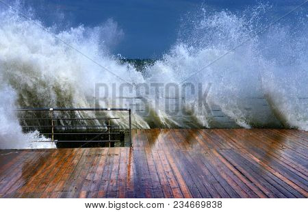 Huge breaking stormy wave. Big wave. The big wave is breaking about the shore     