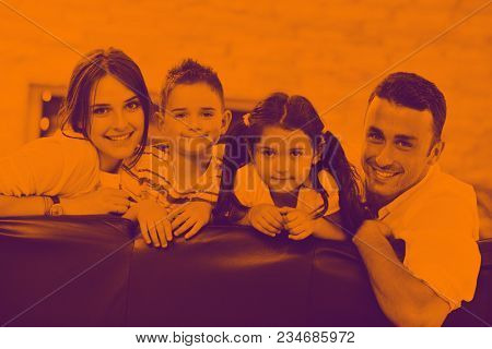happy young family relax and have fun at modern home indooor duo tone