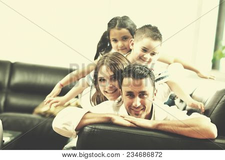 happy young family relax and have fun at modern home indooor