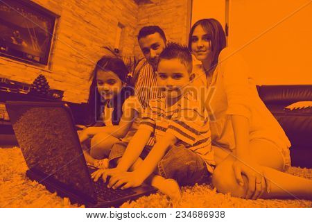 happy young family relax and have fun at modern home indooor duo tone