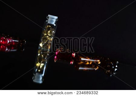 Pill Bottle And Pills In Isolated On Black Concept Pharmacy. With Copy Space.