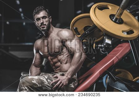 Handsome Model Young Man Training Chest In Gym