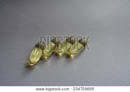 Row Of Four Yellow Fish Oil Capsules