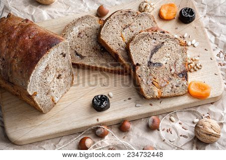 Rye Bread With Nuts, Dried Fruits, Apricots And Prunes, Dessert. The Whole Loaf And The Cut Pieces O
