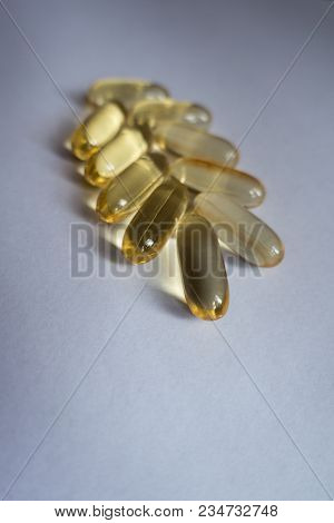 Several Capsules Of Fish Oil In A Shape Of Spike