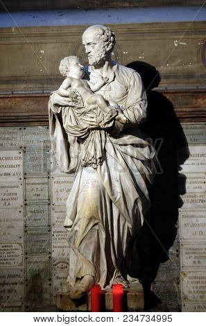 PARIS, FRANCE - JANUARY 04: Saint Joseph holding child Jesus, statue in the Saint Sulpice Church, Paris, France on January 04, 2018.
