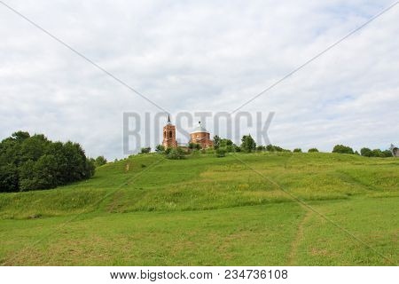 A Christian Temple Stands At The Top Of A Green Mountain In The Summer. Russia, The Kaluga Region. A