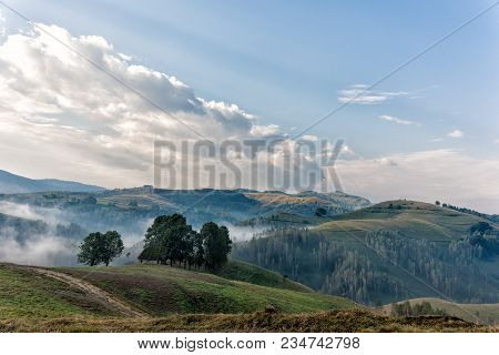 Beautiful Mountain Landscape Of A Foggy Morning With And Old House, Trees And Clouds, Dumesti, Salci
