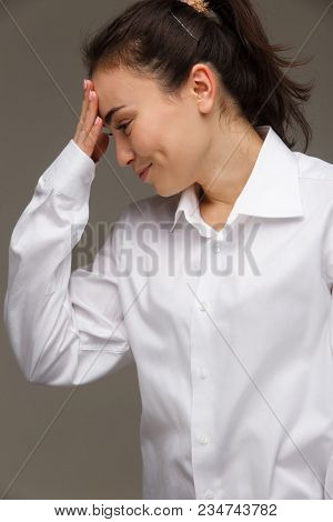 Beautiful Girl In A White Shirt Shows Emotions. On A Light Background.