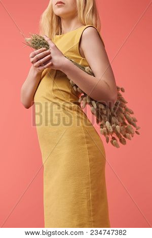 Cropped Shot Of Young Woman With Bouquet Of Lagurus Isolated On Red