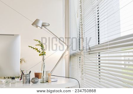Workspace Of Entrerpreneur With Lamp And Flower Vase