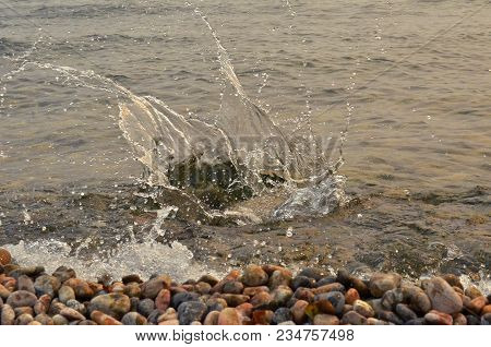 Splash Water With Spray And Stone Beach