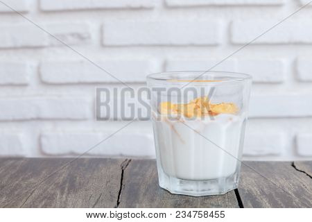 Close Up A Glasses Of Milk And Granola On Wooden Table