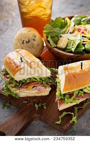 Italian Sub Sandwich With Salami, Ham And Caesar Salad