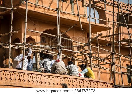 Jaipur, India - January 12, 2018: Men Builders Are Resting. Scaffolding. Repair Of Historic Building