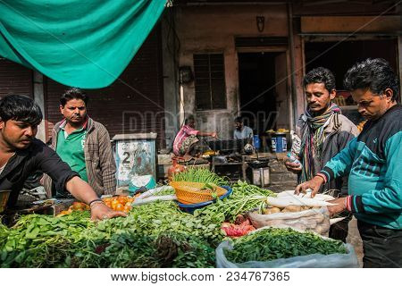 Jaipur, India - January 12, 2018: Trade On The Street. Vegetable Shop. The Man Is Selling Greens