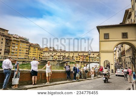Florence, Italy, June 2015: Tourists Walking And Taking Pictures Along The Famous Lungarno Near Pont
