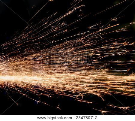 Bright Sparks Of Metal Against Dark Background