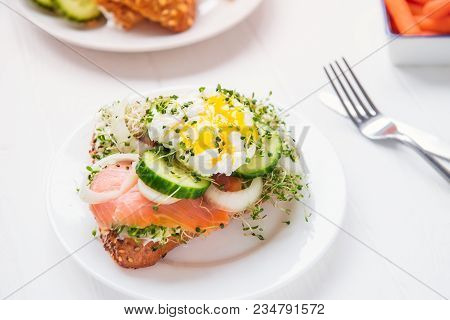 Cereal Bun With Egg Benedict, Smoked Salmon, Sprout Micro Greens, Onion And Cucumber Slices, Cream C