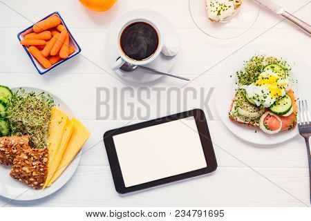 Top View Tablet With Blank Copy Space Screen And Healthy Breakfast With Coffee On The White Wooden T