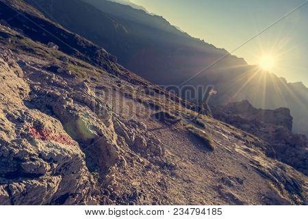 Mountain Direction Sign Light By Setting Sun. Brenta Dolomites.