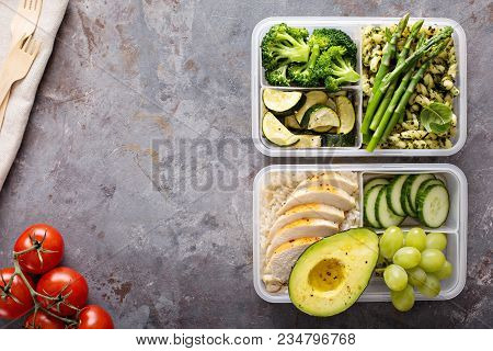 Green And Healthymeal Prep Containers With Chicken And Pasta With Green Pesto Sauce And Vegetables