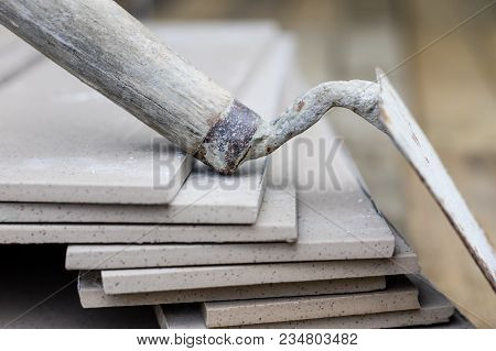 Laying And Cutting Tiles. Tools And Building Materials At A Working Position. Tiles For Industrial A
