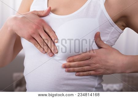 Close-up Of A Woman's Hand On Breast
