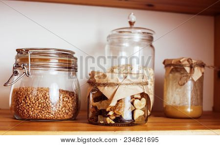 Real Comfort Wooden Kitchen With Breakfast Ingredients Close Up In Glass, Honey, Oatmeal, Milk, Mues