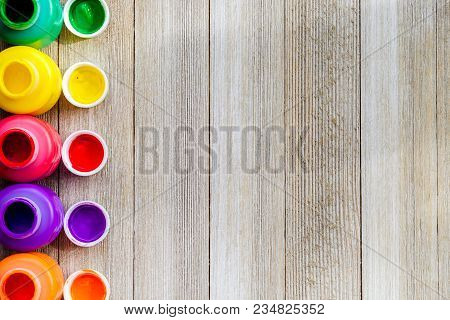 Colorful Open Paint Bottels On Rustic Wooden Background With Copy Space, Top View/arts And Crafts Ba